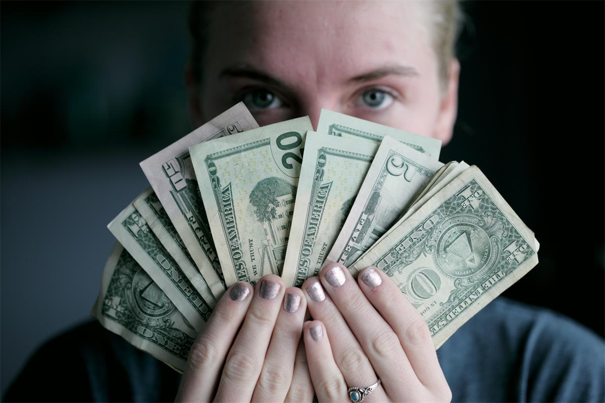 person holding cash fanned out